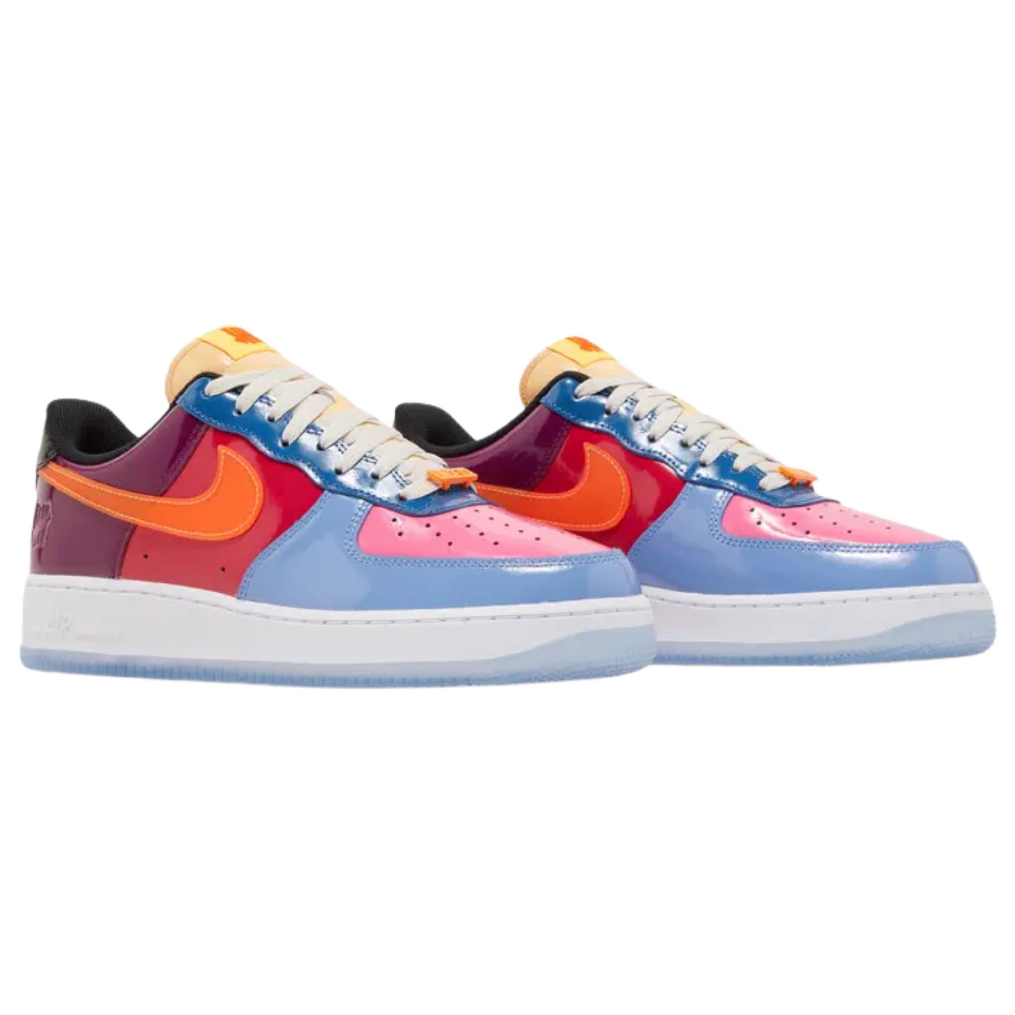 The Undefeated x Nike Air Force 1 Low ‘Total Orange’ features a glossy patent leather upper with a bold mix of blue, fuchsia, crimson, purple, and black. The shoe includes a stitched orange Swoosh, UNDFTD lace dubrae, and a debossed Nike Air logo on the heel tab. Undefeated's Five Strikes graphic appears on the lateral heel and woven tongue tag. The sneaker is set on a white midsole with encapsulated Air-sole cushioning and a translucent rubber outsole for a stylish, comfortable finish.