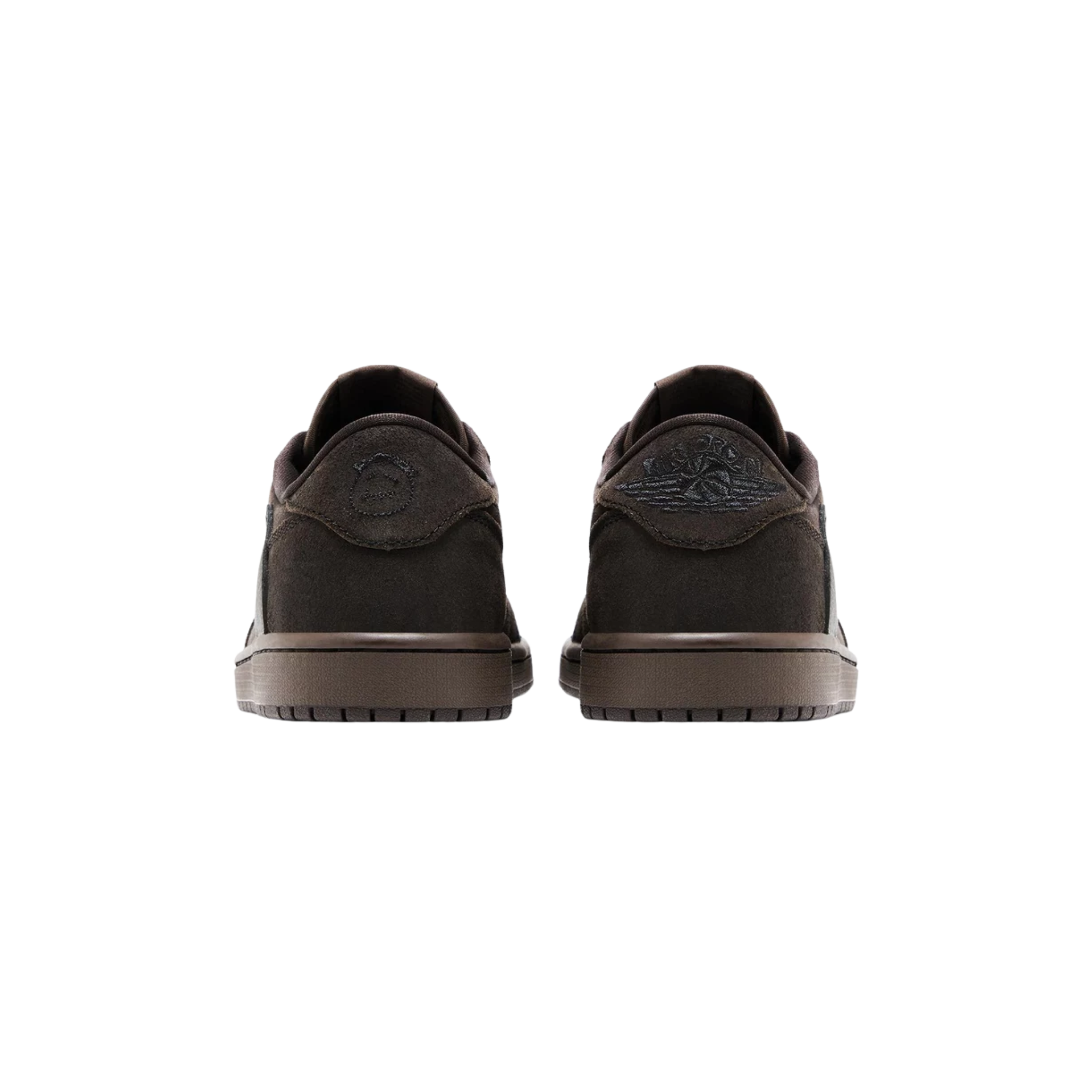 Travis Scott x Air Jordan 1 Retro Low OG SP 'Velvet Brown' featuring a black tumbled leather and brown suede upper with a reverse Swoosh. The sneaker includes a woven Nike Air tag on the brown nylon tongue, mismatched Cactus Jack and Jordan Wings branding on the back tabs, and a brown rubber cupsole with an encapsulated Air-sole unit in the heel.