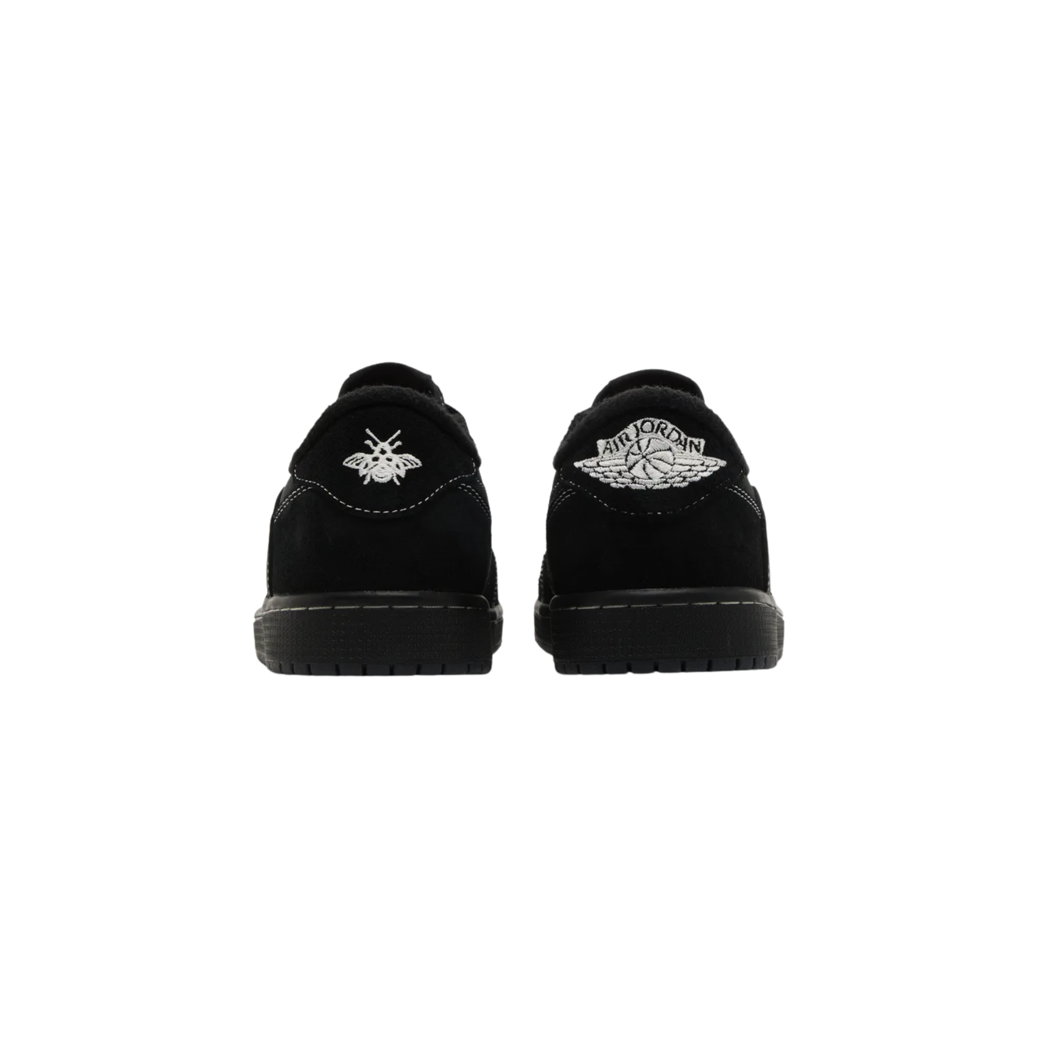 Travis Scott x Air Jordan 1 Retro Low OG SP ‘Black Phantom’ featuring a black nubuck upper with tonal suede overlays and contrast white stitching. The sneaker includes a reverse Swoosh on the lateral side, a traditional Swoosh on the opposite side with Cactus Jack branding, mismatched heel tabs with a retro Wings logo on the right shoe and an embroidered bee motif on the left, and a black rubber cupsole with stitched sidewall construction and encapsulated Air-sole cushioning.